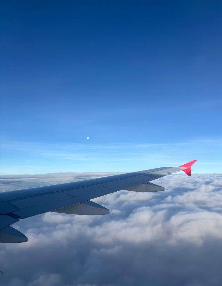 Plane window view symbolising booking flights and planning travel