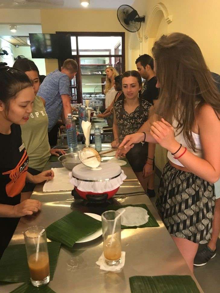 Preparing local dishes during a cooking class booked through GetYourGuide