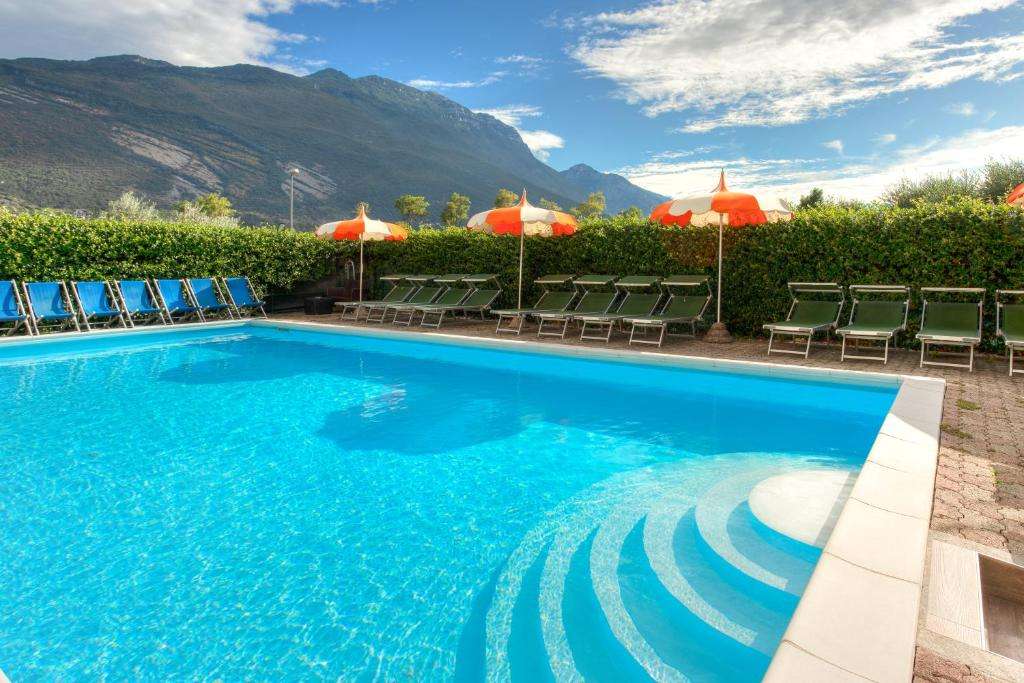 hotel pool view of Hotel Roma in Torbole, northern Lake Garda, Italy.
