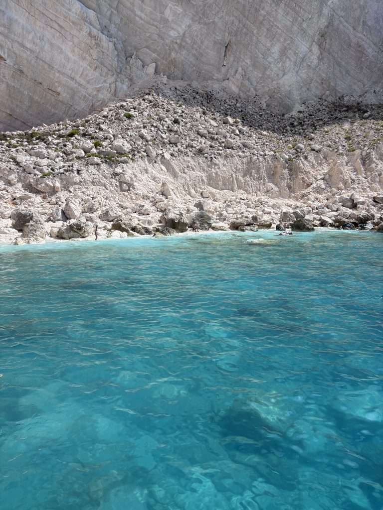 Clear blue water surrounding the caves along the coast of Zante